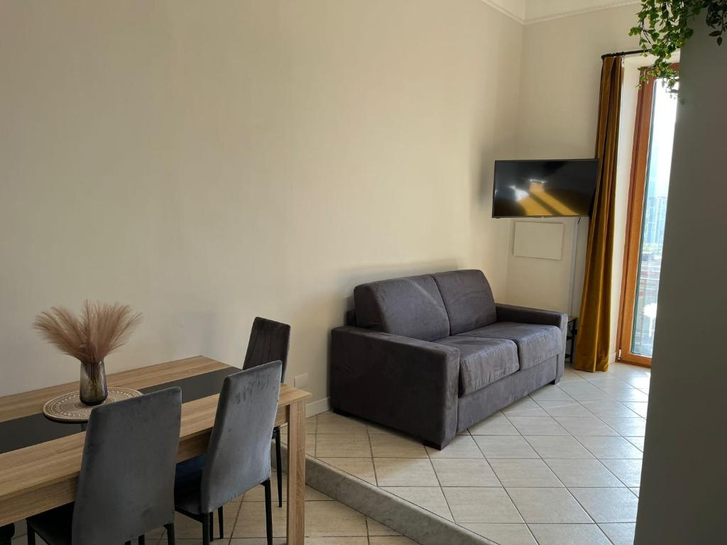 a living room with a couch and a table and a chair at Napoli studio 106 in Naples