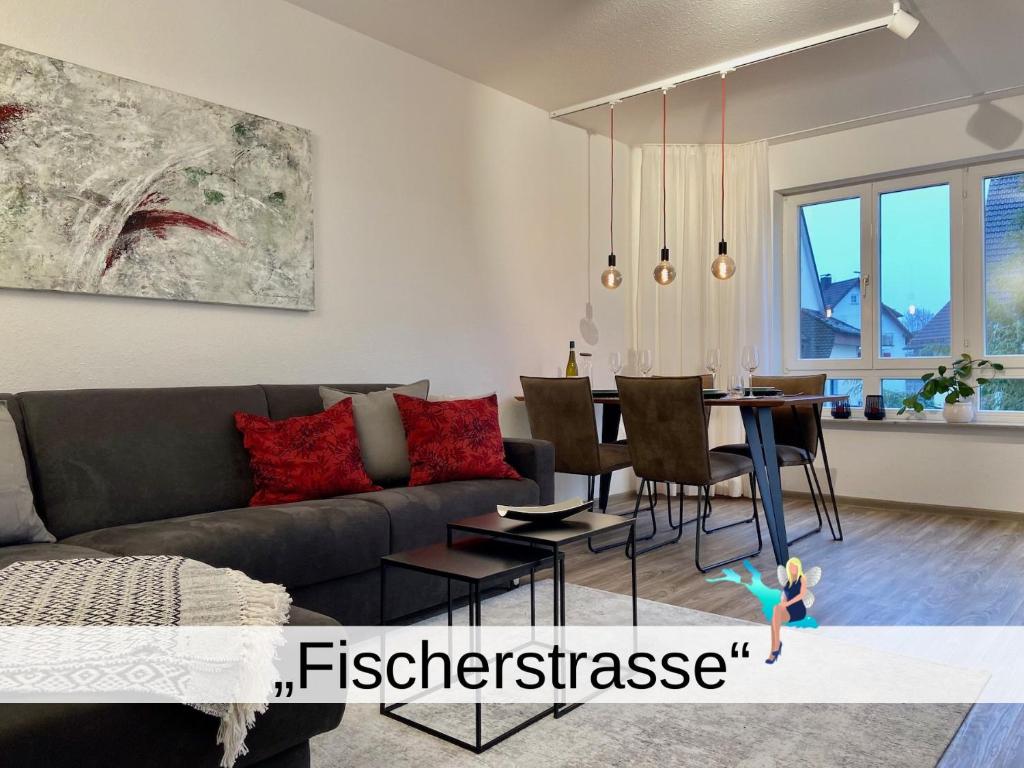 a living room with a couch and a table at Ferienwohnung Fischerstrasse - modern und seenah mit Wohlfühlcharakter in Langenargen