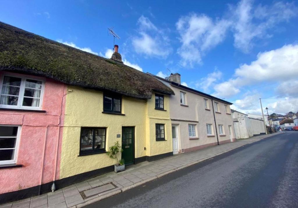 a row of colourful houses on a street at Lemon Cottage in Hatherleigh