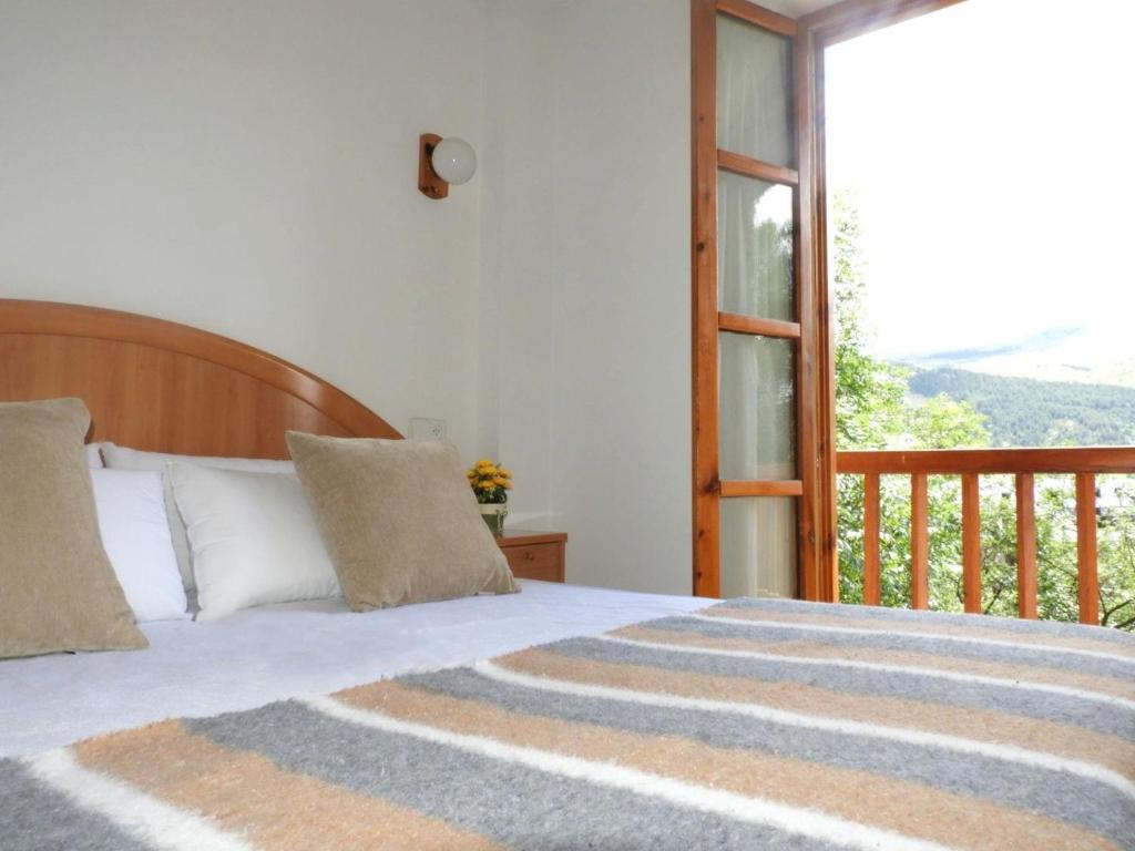 a bedroom with a bed and a balcony at UNIQUE EXPERIENCE - Boí-Taüll Apartment in Pla de l'Ermita