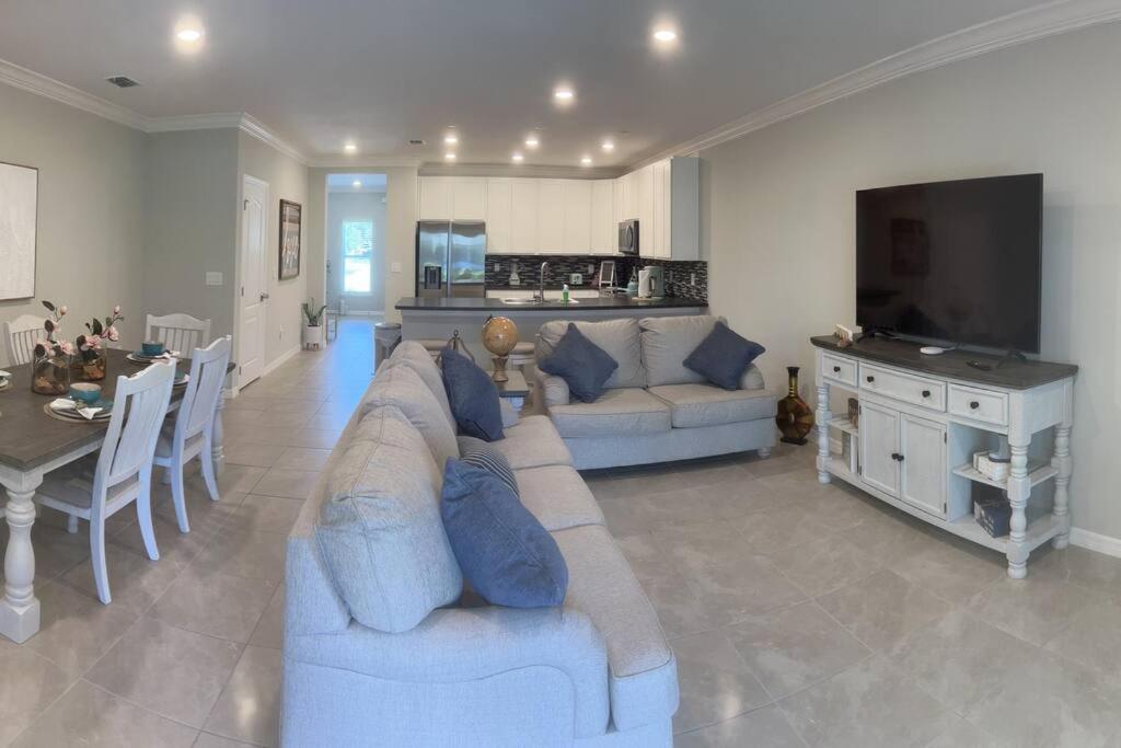 a large living room with a couch and a television at Luxurious Farm Style House in Kissimmee