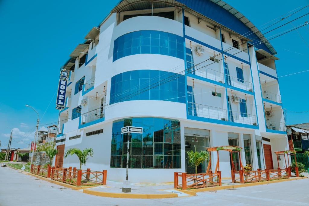 a blue and white building with a playground at HOTEL RAYMONDI in Pucallpa