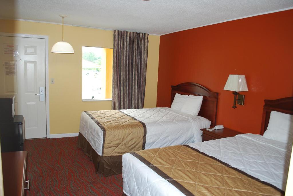 a hotel room with two beds and a window at Duffys Motel - Calhoun in Calhoun