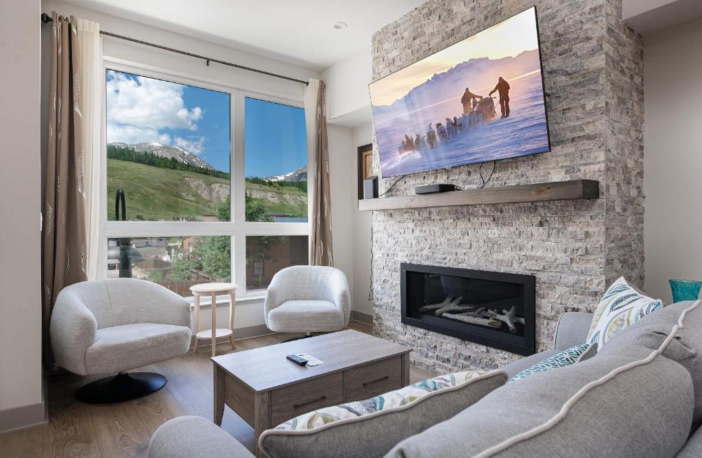 a living room with a couch and a fireplace at Fourth Street Crossing Traverse Townhome: Stylish Retreat in Silverthorne