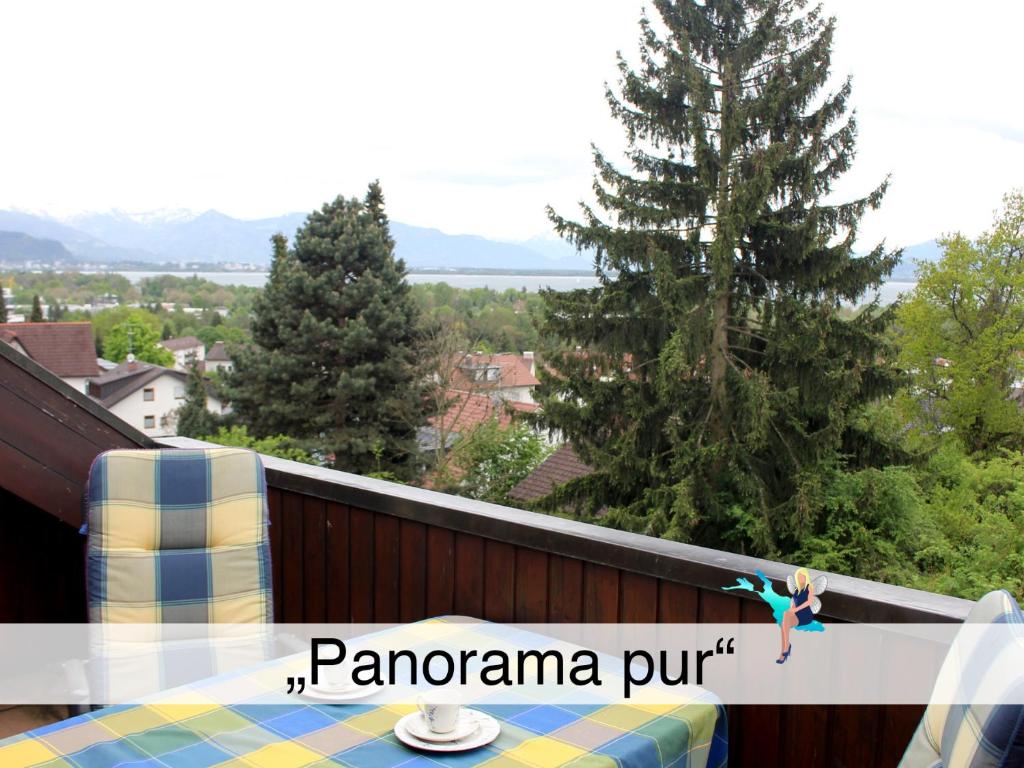 a view of a balcony with a table and trees at Ferienwohnung Panorama pur in Lindau