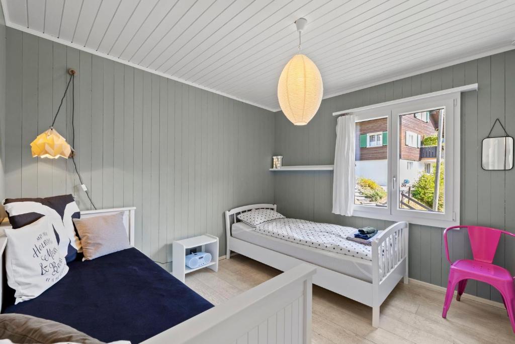 A bed or beds in a room at Sunny Design Chalet in Engelberg with spectacular view on Mount Titlis