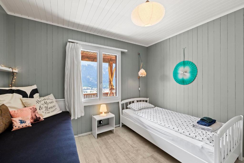 A bed or beds in a room at Sunny Design Chalet in Engelberg with spectacular view on Mount Titlis