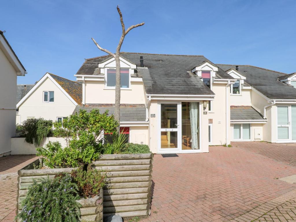 a large white house with a brick driveway at The Beach House in Newquay