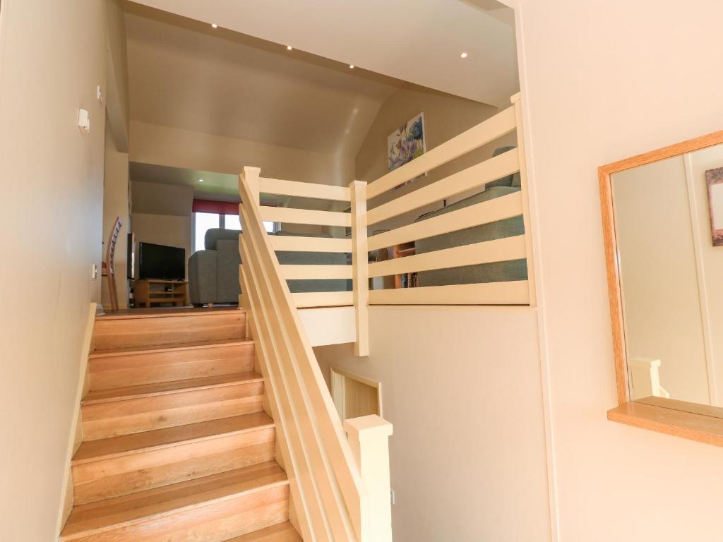 a spiral staircase in a house with a mirror at The Beach House in Newquay