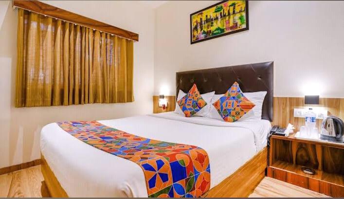 a bedroom with a large bed in a room at Deluxe Residency Nr- Mumbai International Airport in Mumbai