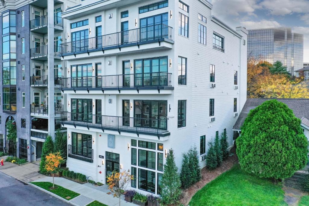 an aerial view of a white apartment building with balconies at 121 Hotel by AvantStay Chic Modern Hotel In Nashville in Nashville