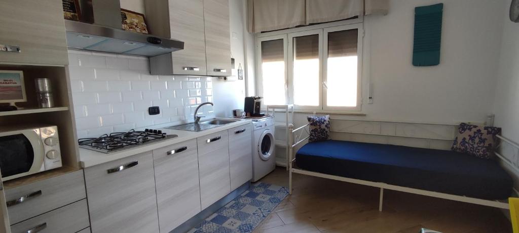 a small kitchen with a sink and a stove at Casatua in Taranto