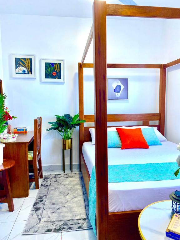 a bedroom with a bunk bed and a table at Pilipili Kijani Luxury homes in Mombasa