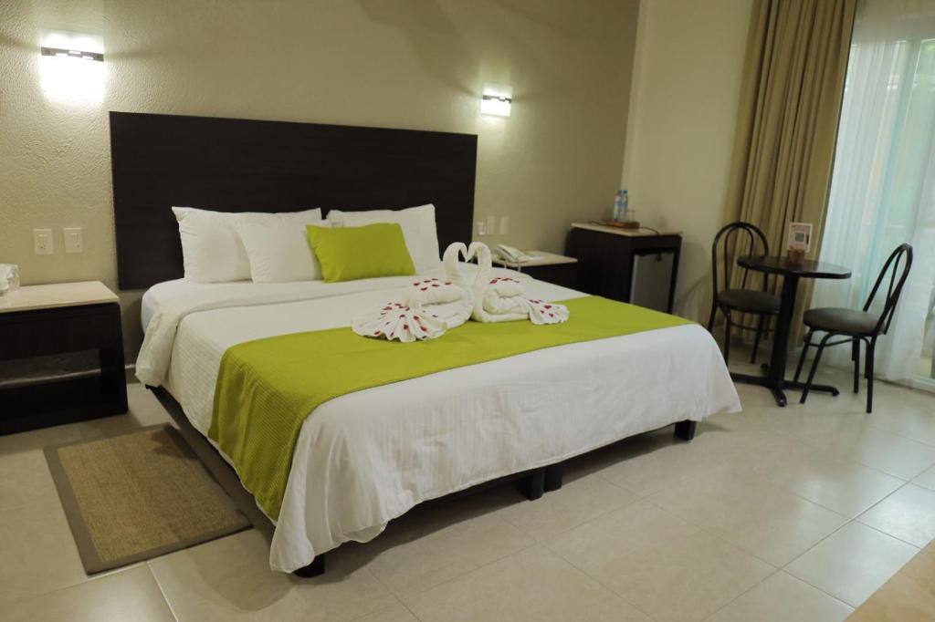 Postel nebo postele na pokoji v ubytování Hotel Chablis Palenque