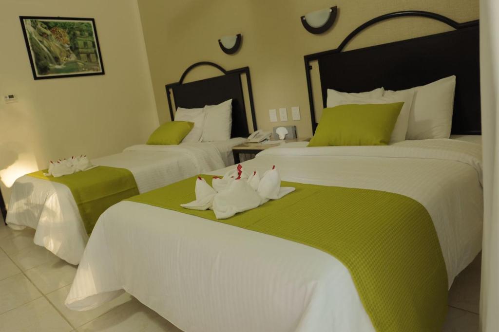 Postel nebo postele na pokoji v ubytování Hotel Chablis Palenque