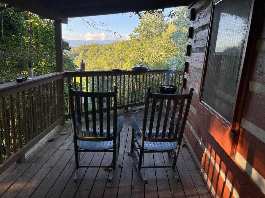 two chairs sitting on the porch of a house at Whiskey Run Cabin, Spectacular Mountain Views in Bryson City