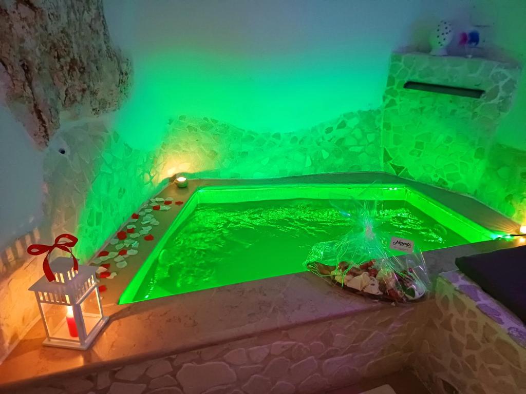 a green glow in the dark pool in a room at Suite 800 in Ostuni