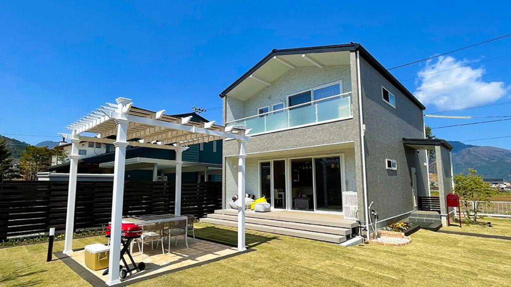 a house with a pergola on a lawn at [Mt, Fuji koko] Newly built rental villa with dogs - Vacation STAY 26673v in Fujikawaguchiko