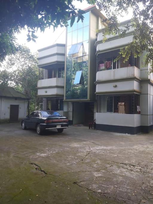 a car parked in front of a building at Syed monjil in Kamālpur
