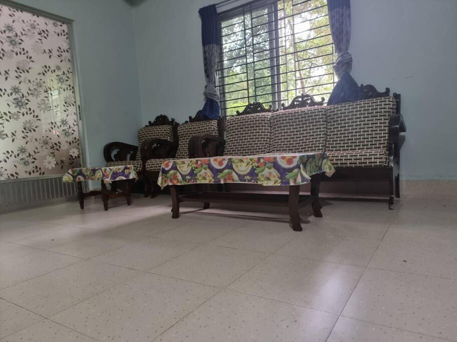 a group of benches in a room with a window at Syed monjil 