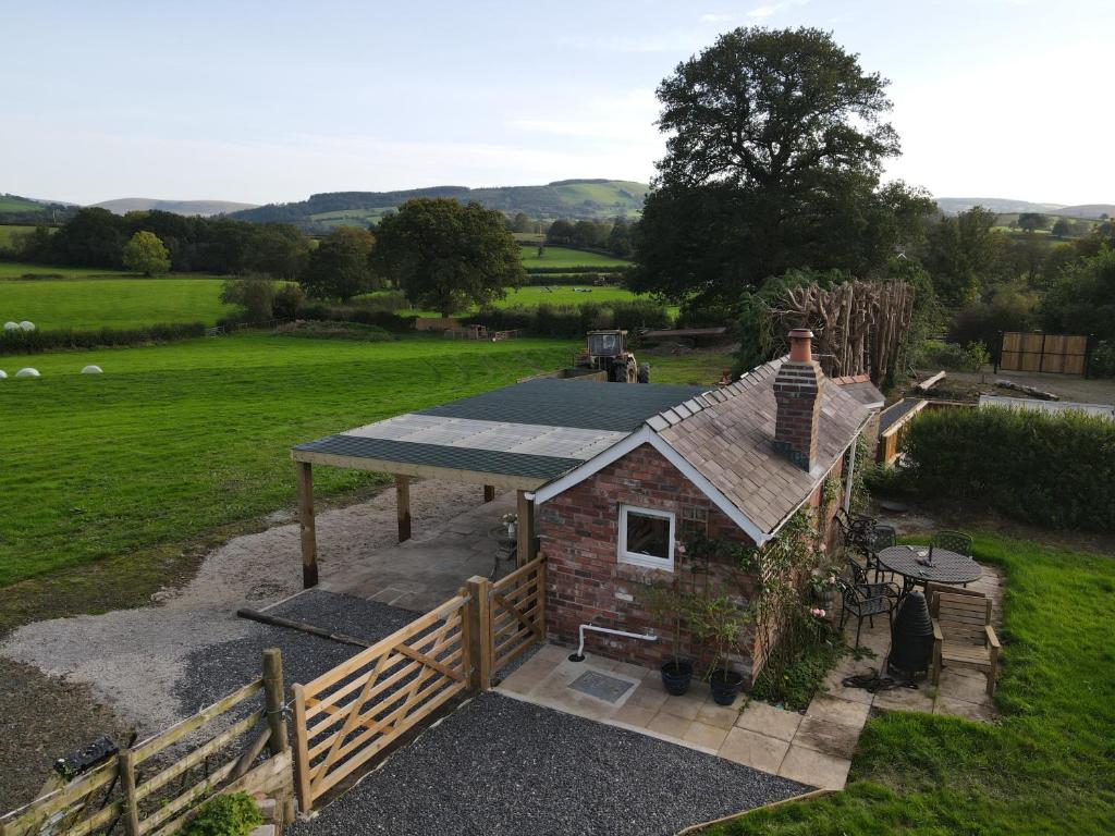 an overhead view of a small house in a field at Quaint, rustic cabin with period features, stunning views & hot tub in Llangadog