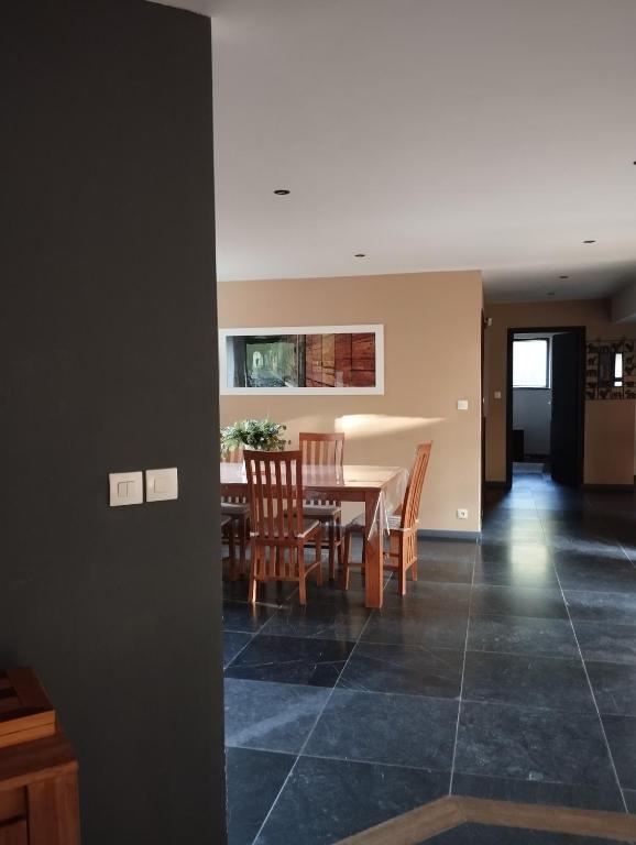 a dining room and living room with a table and chairs at VILLA KB&#39;HOME in Le Touquet-Paris-Plage