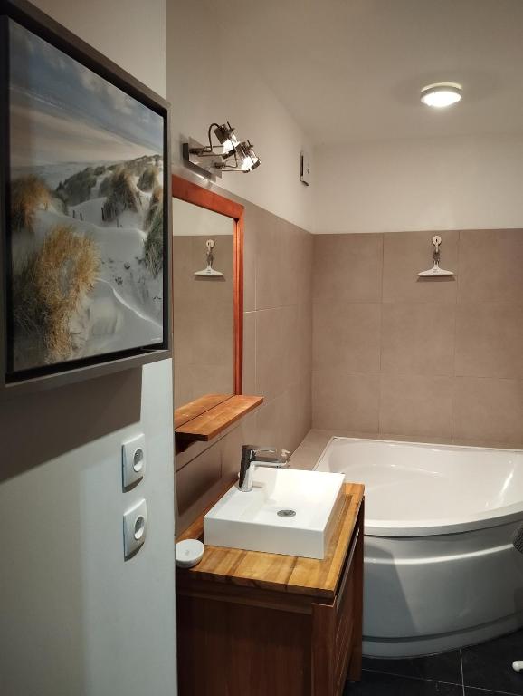 a bathroom with a tub and a sink and a bath tub at VILLA KB&#39;HOME in Le Touquet-Paris-Plage