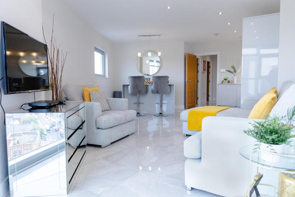 a living room with a couch and a table at Luxury Cardiff City Centre Apartments in Cardiff