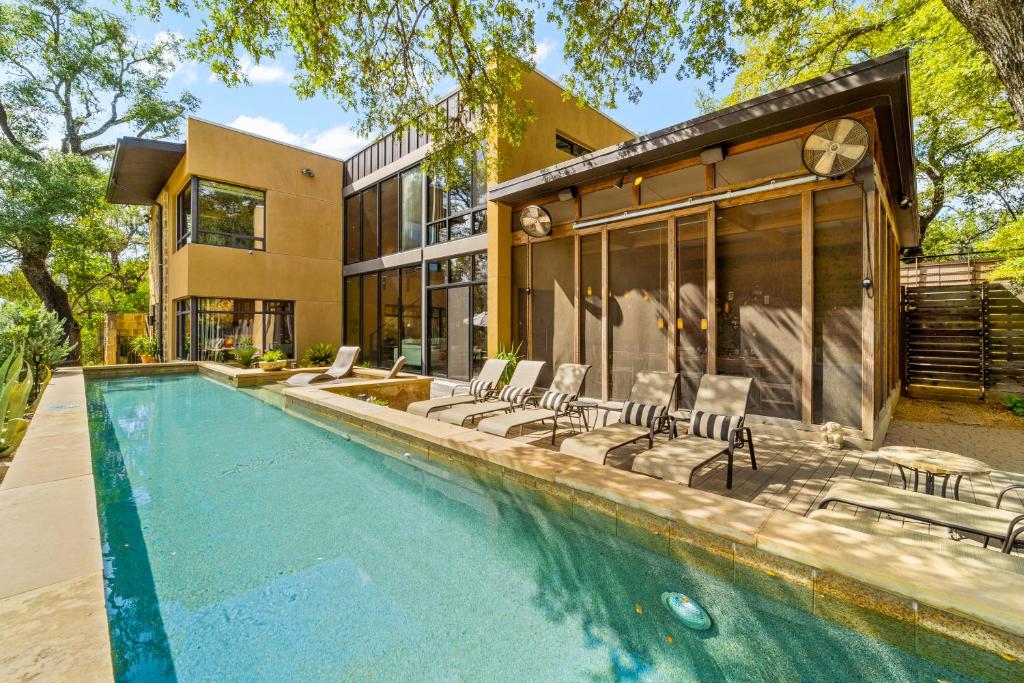 an exterior view of a house with a swimming pool at The Haven by Lodgewell - Where serenity meets sanctuary in Austin