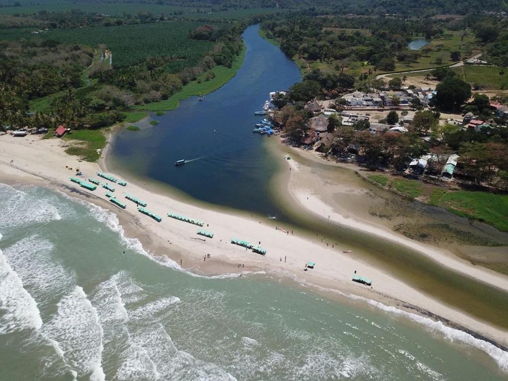 an aerial view of a beach with a group of people at HOSTAL CASA ALFON BURITACA in Santa Marta