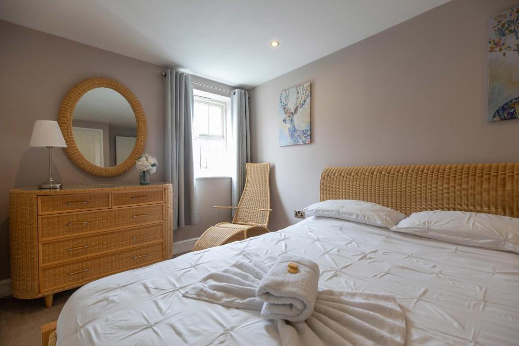 a bedroom with a bed with a stuffed animal on it at Regent House in Thirsk