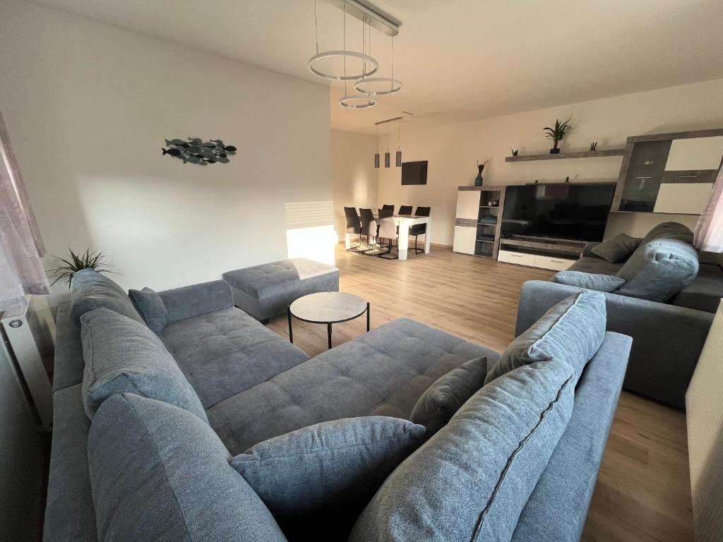 a living room with a large blue couch and a living room with at NP-Apartments Blasewitz in Dresden