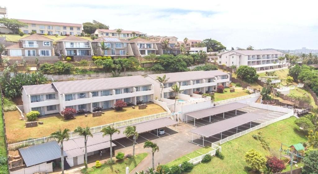 an aerial view of a large building with palm trees at Illovo Beach View Apartment at Illovo Views in Kingsburgh