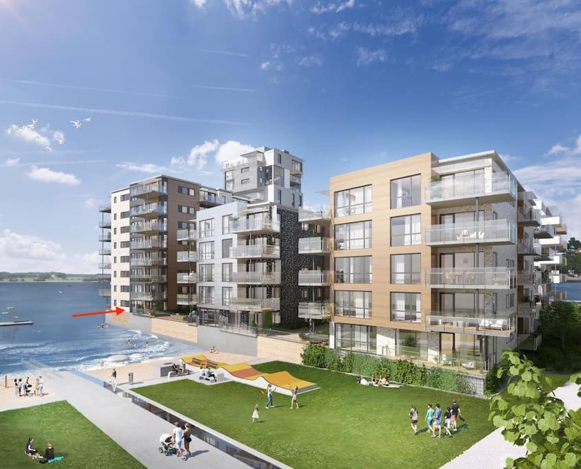 una representación de un complejo de apartamentos junto al agua en På stranden, midt i Tønsberg, en Tønsberg