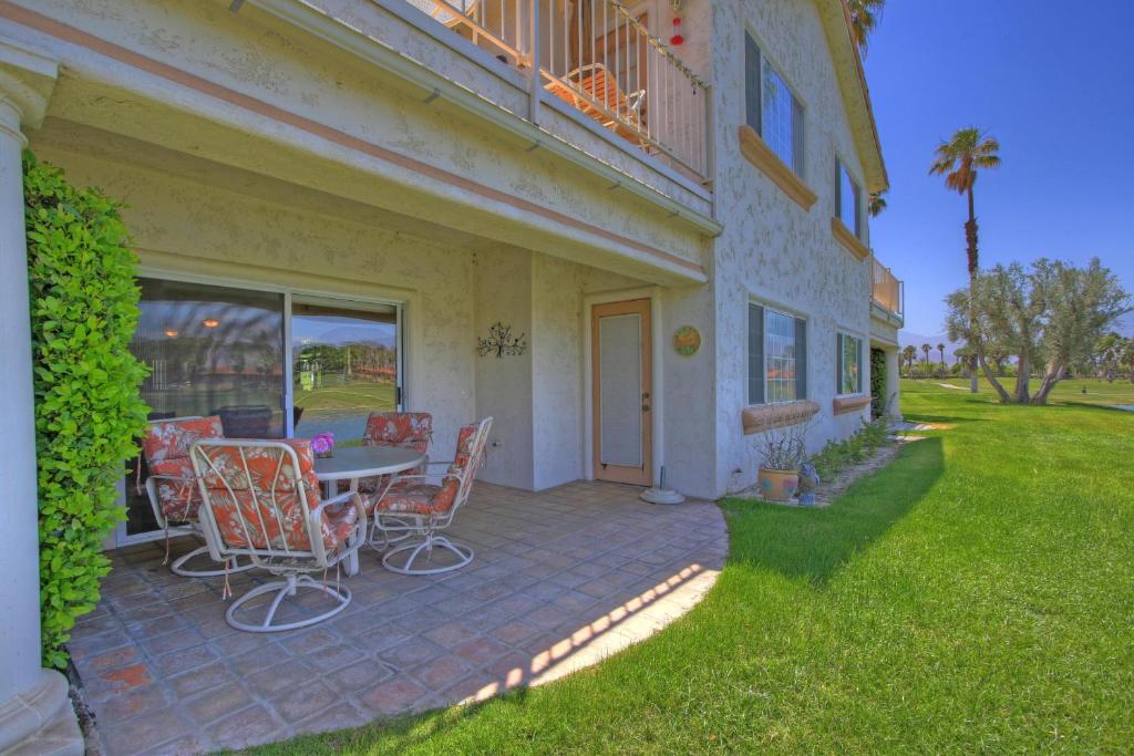 a patio with a table and chairs next to a building at DL831 - Desert Falls Circle in Palm Desert