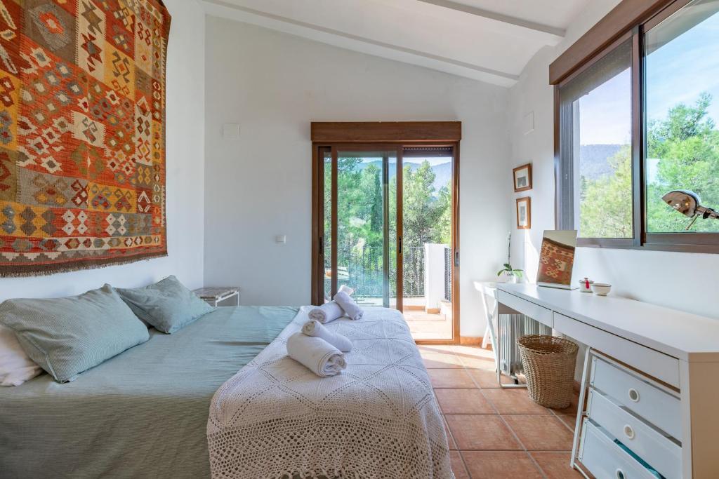 a bedroom with a bed with two stuffed animals on it at EL SECADERO in Alcudia de Veo