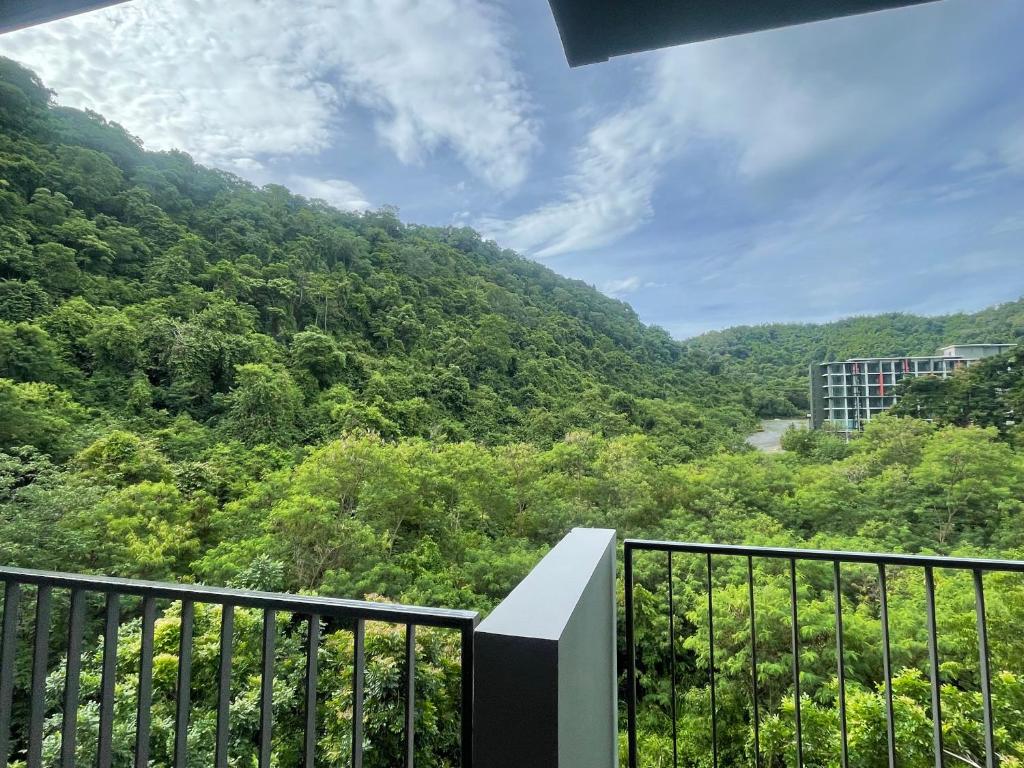 a balcony with a view of a mountain at The Valley at Sunshine, Panoramic in Pak Chong