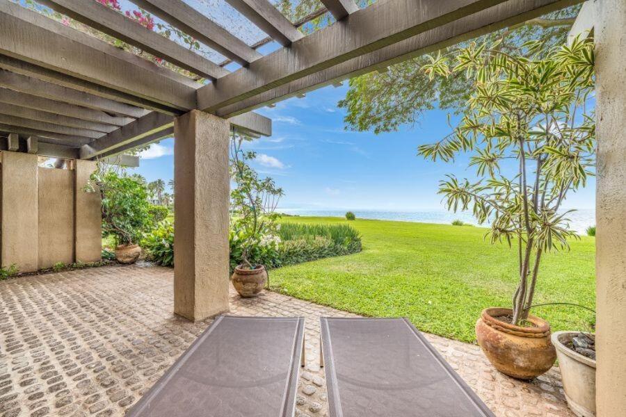 an outdoor patio with two yoga mats and a view of the ocean at WAILEA ELUA, #1305^ condo in Wailea