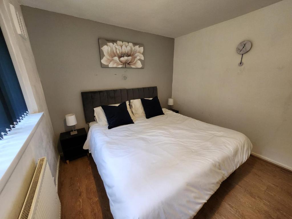 バーミンガムにあるGreenvale Apartmentのベッドルーム1室(白いシーツと枕のベッド1台付)