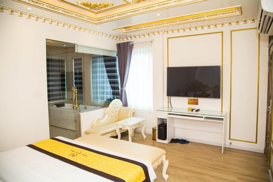 a bedroom with a bed and a tv and a chair at Khách Sạn Cường Thanh 1 in Ho Chi Minh City