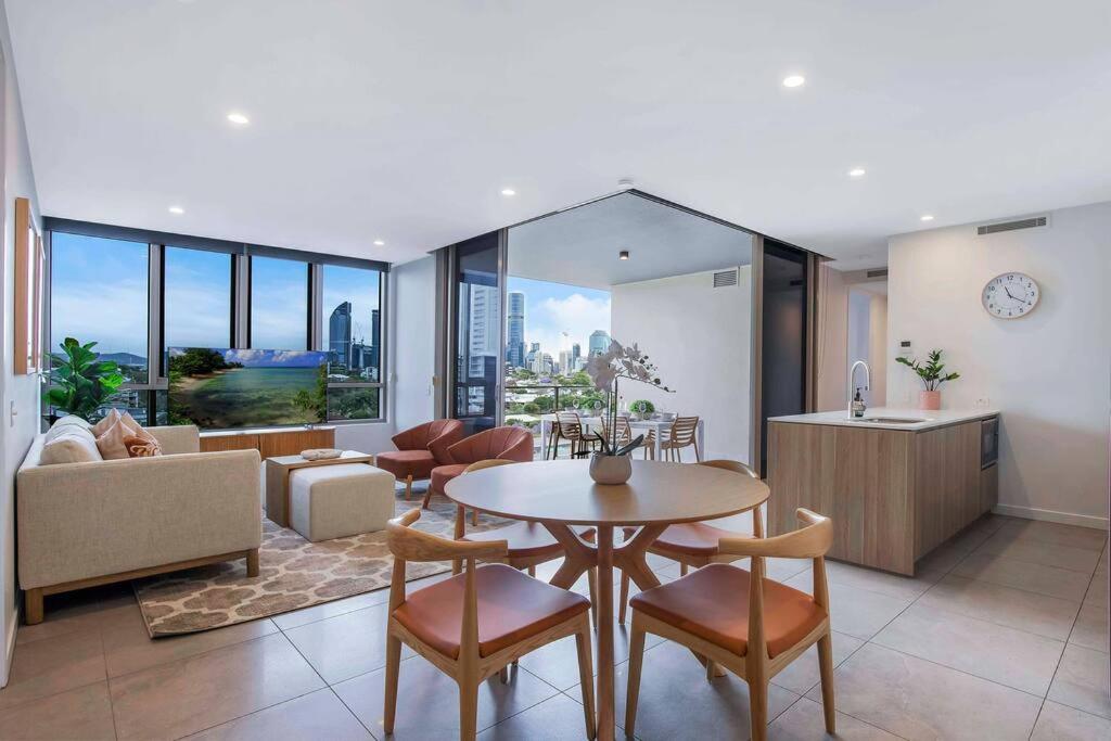 a living room with a table and chairs at Gabba Oasis:Luxury 3BRM Apt Pool in Brisbane