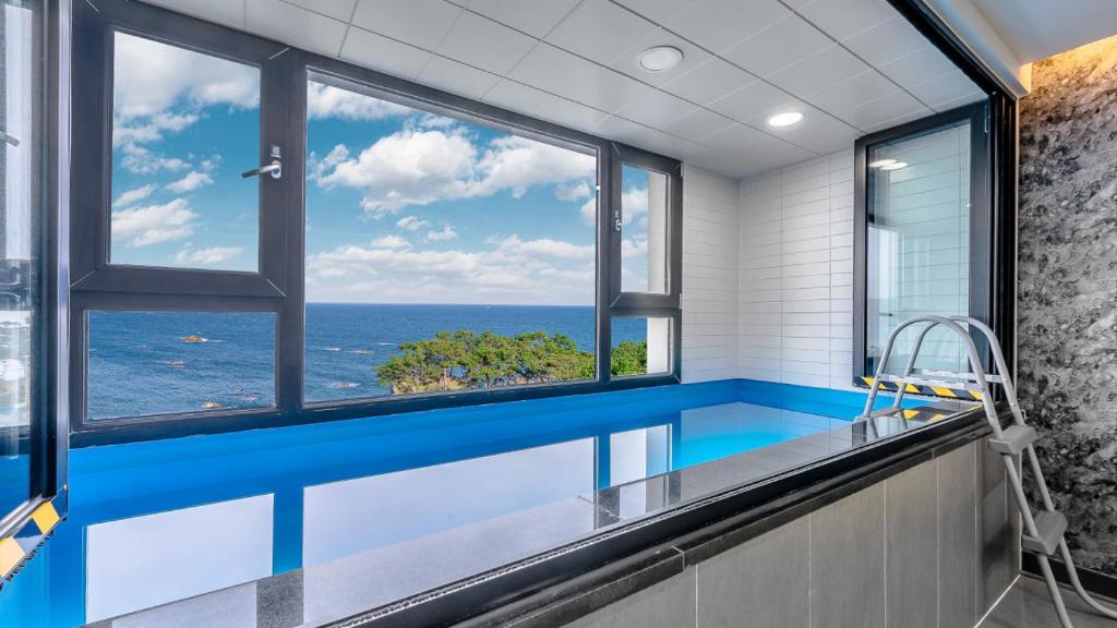 a swimming pool with a view of the ocean at Beachhill Pool Villa in Gyeongju