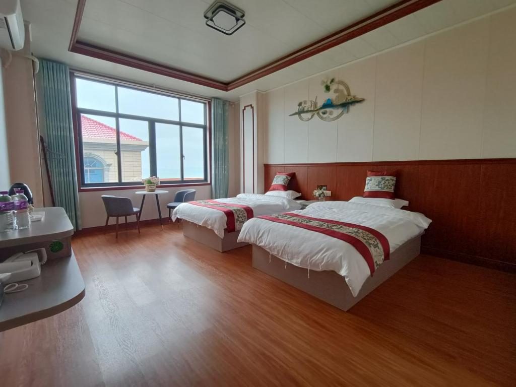 Postel nebo postele na pokoji v ubytování Meizhou Cloudy B&B