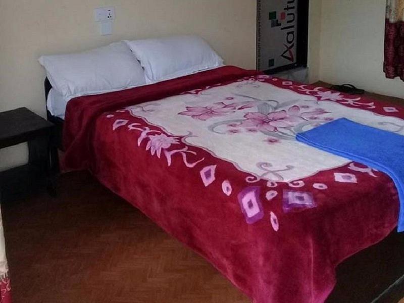 Postel nebo postele na pokoji v ubytování GAUTAM GARDEN GUEST HOUSE