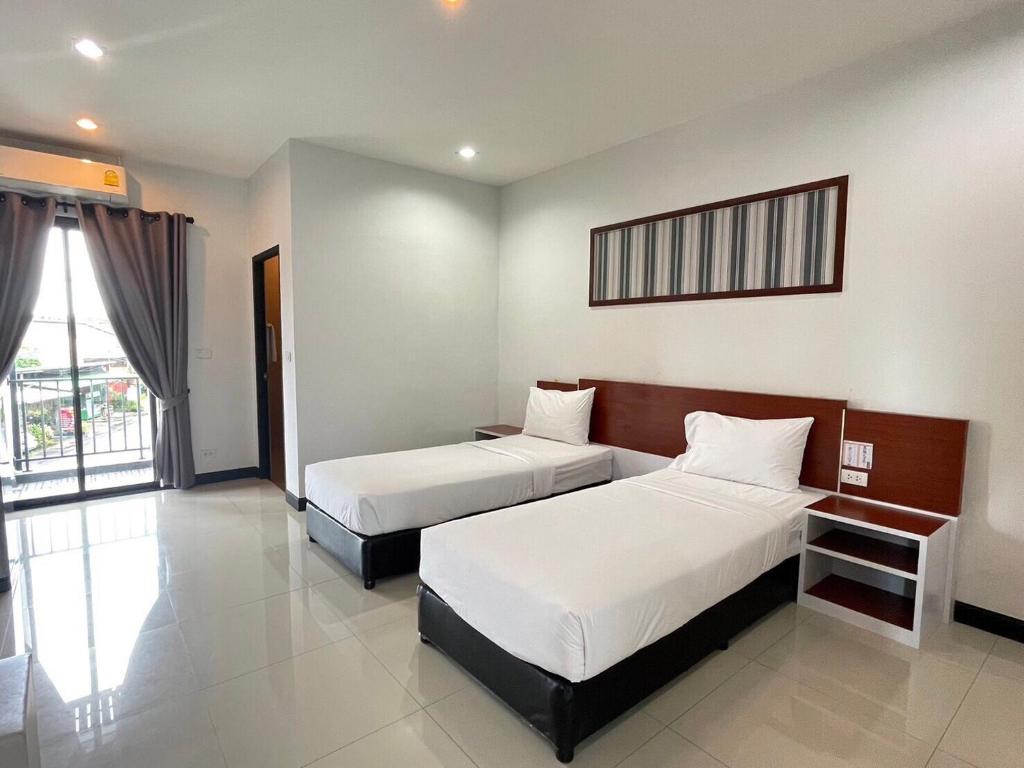 Postel nebo postele na pokoji v ubytování River Hotel Pattani
