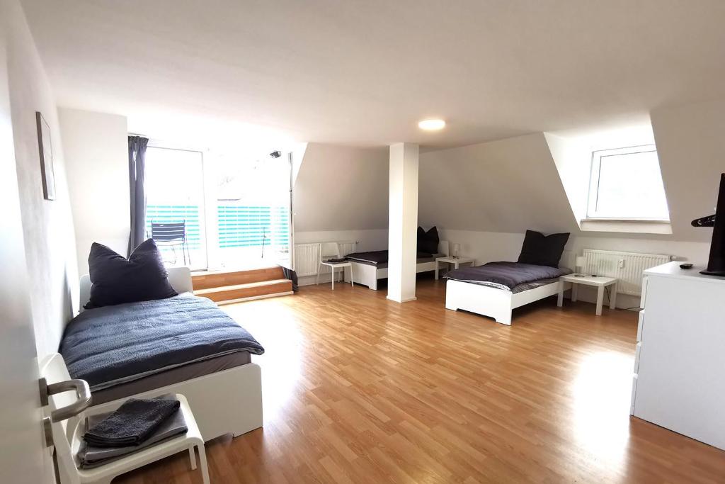 a bedroom with a bed and a living room at Spacious Apartment with Balcony & WiFi in Wetzlar