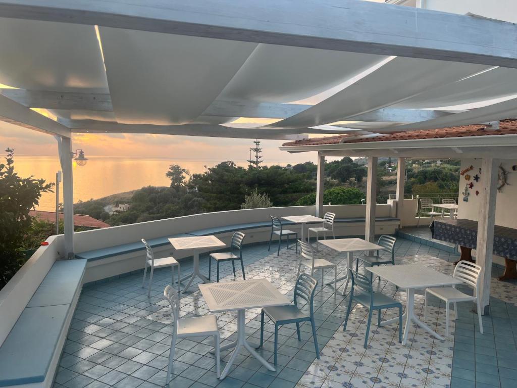 a patio with tables and chairs on a roof at Miriasol Bed and Breakfast in Capo Vaticano