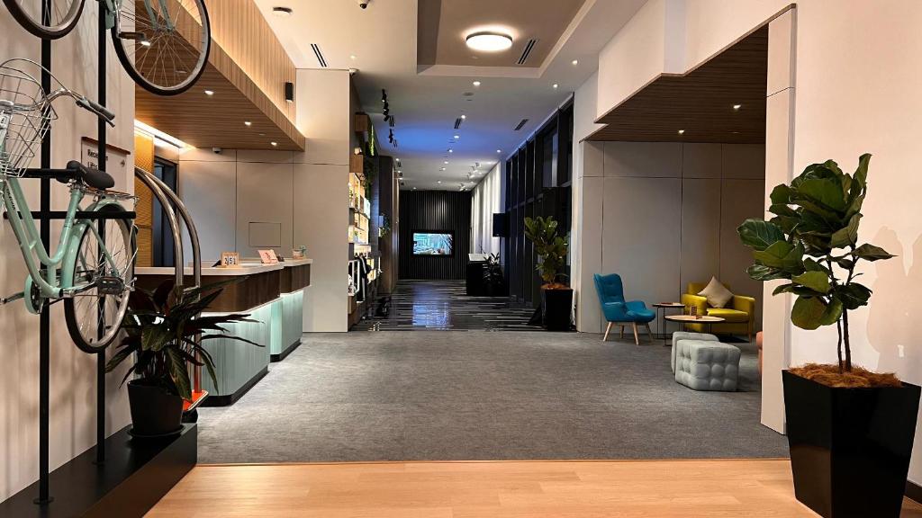 an office lobby with a hallway with plants at INNSiDE by Meliá Kuala Lumpur in Kuala Lumpur