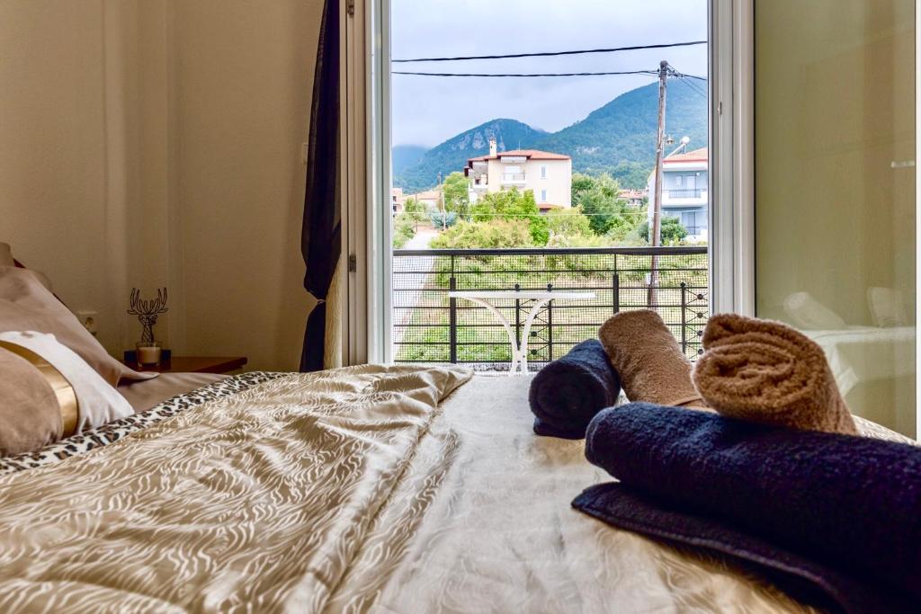 a bedroom with a bed and a window with a view at Mar y Montaña Apartments Litochoro in Litochoro