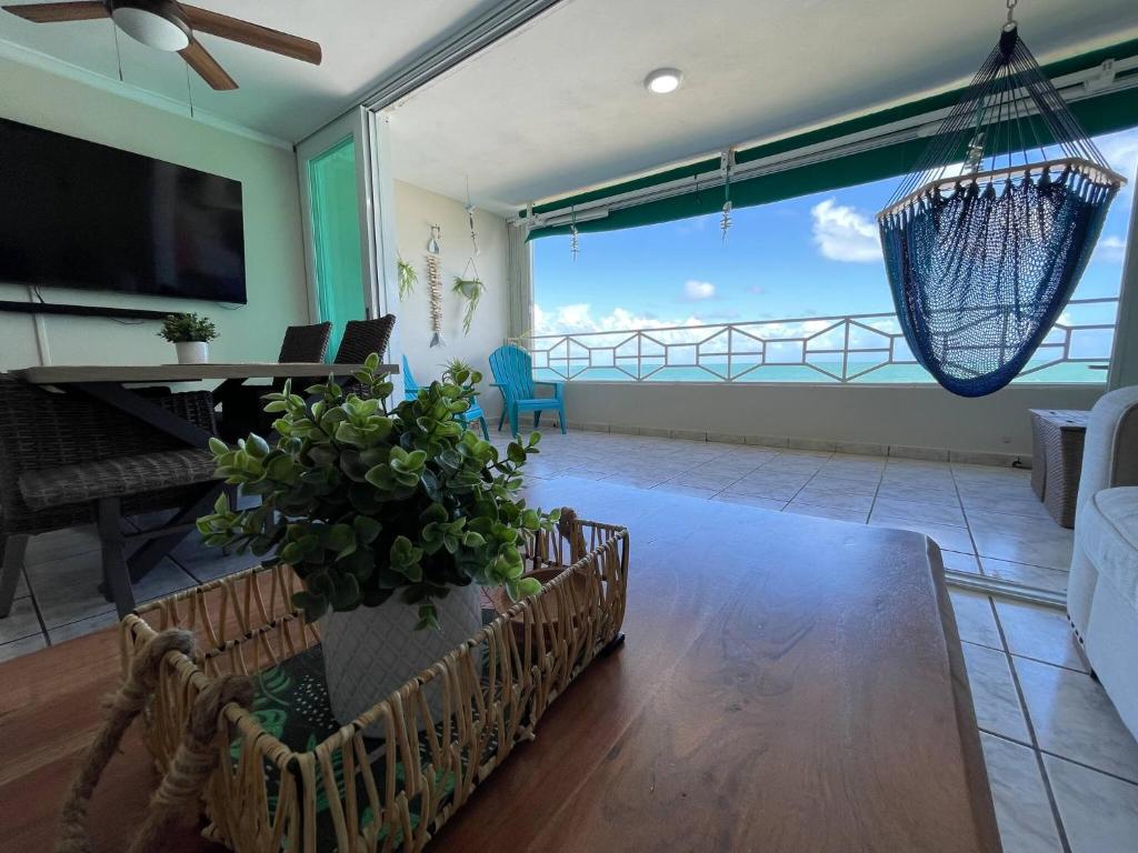 a living room with a view of the ocean at True Beachfront Oasis With Amazing Views Life in Luquillo